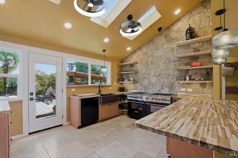 a kitchen with stainless steel appliances granite countertop a stove and a sink