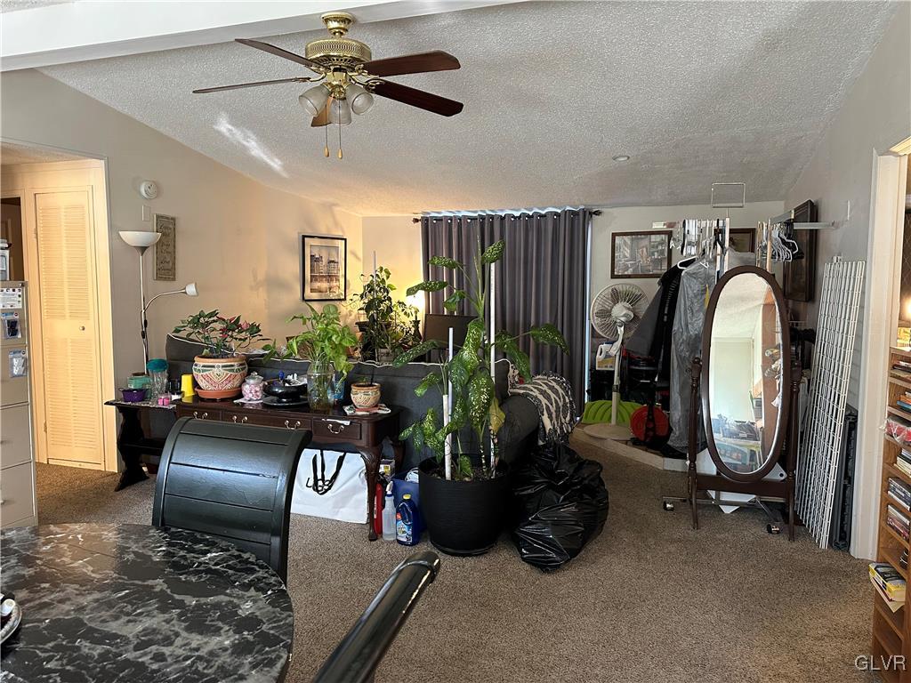 513 Norman Road Nazareth, PA 18064 - Photo 7 of 20 a living room with furniture gym equipment and a chandelier