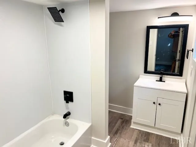 a kitchen with a sink a refrigerator and cabinets