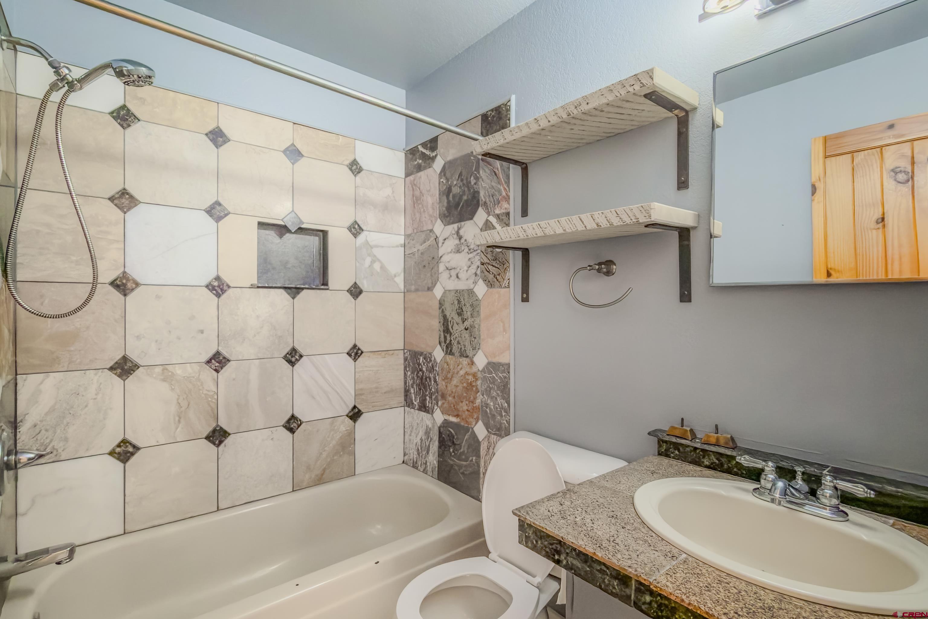 27 Crystal Road, Unit 7 Crested Butte, CO 81225 - Photo 17 of 23 a bathroom with a sink toilet and shower
