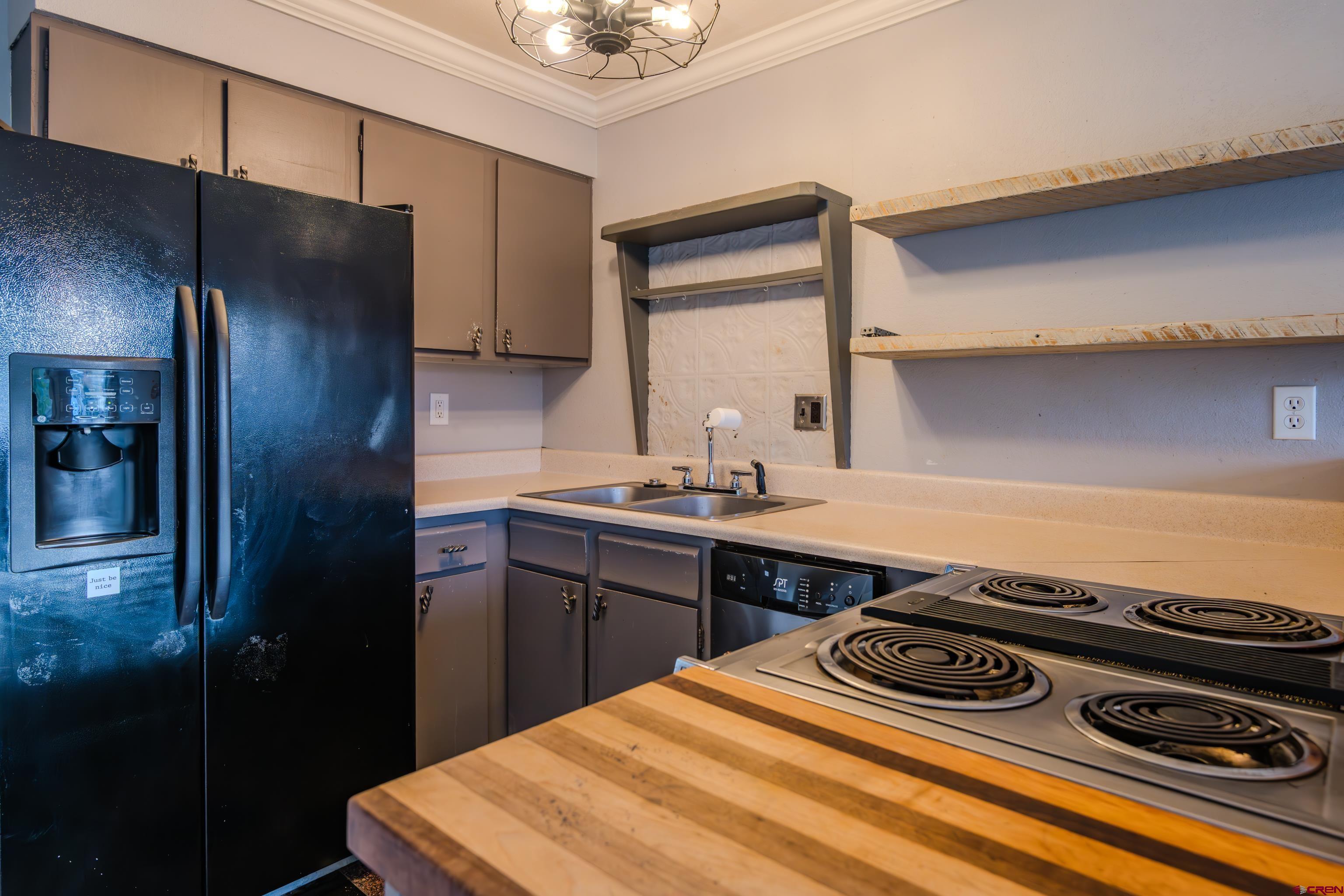 27 Crystal Road, Unit 7 Crested Butte, CO 81225 - Photo 4 of 23 a kitchen with a stove and a refrigerator