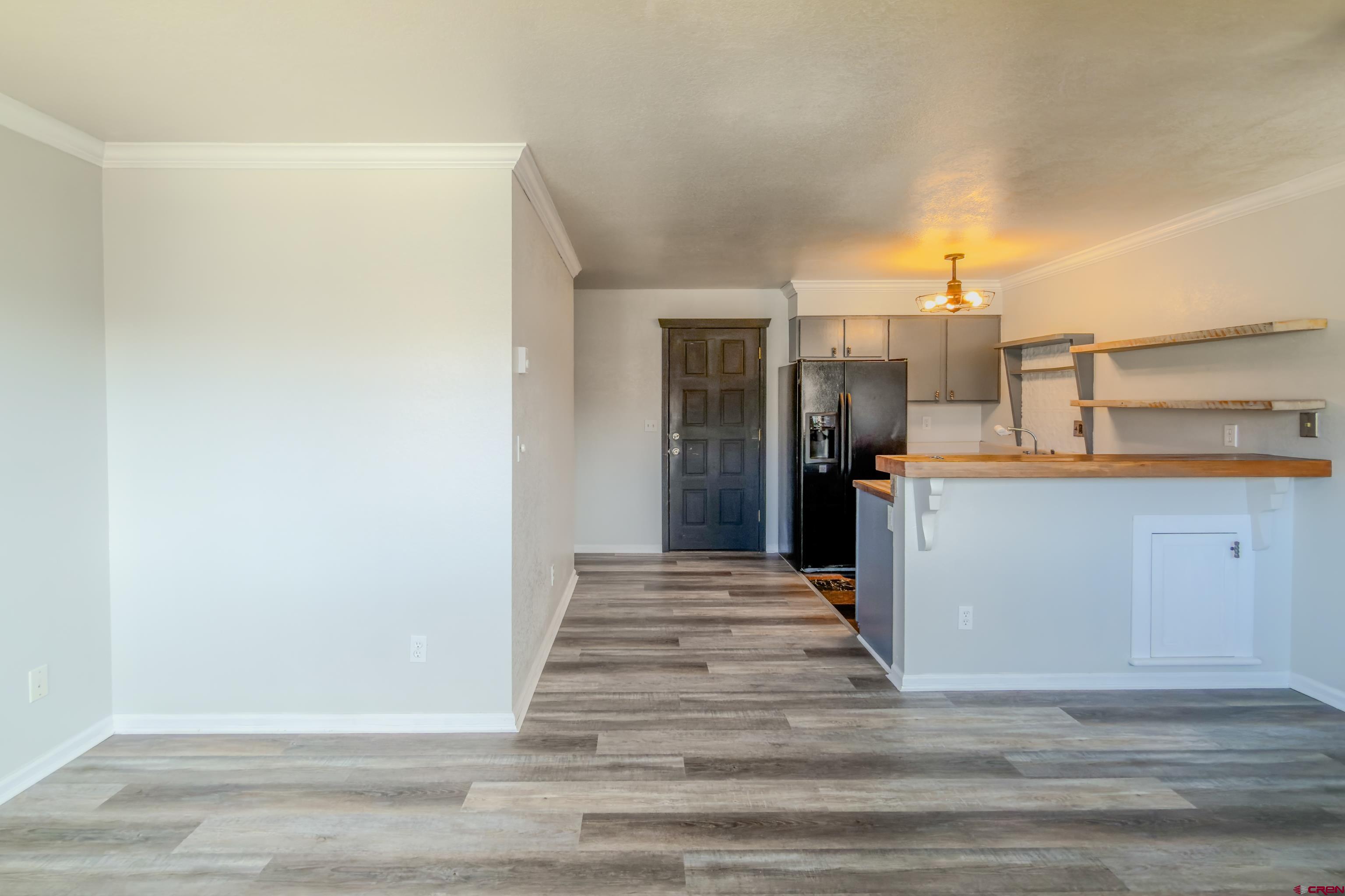 27 Crystal Road, Unit 7 Crested Butte, CO 81225 - Photo 8 of 23 a view of a kitchen with wooden floor and a refrigerator