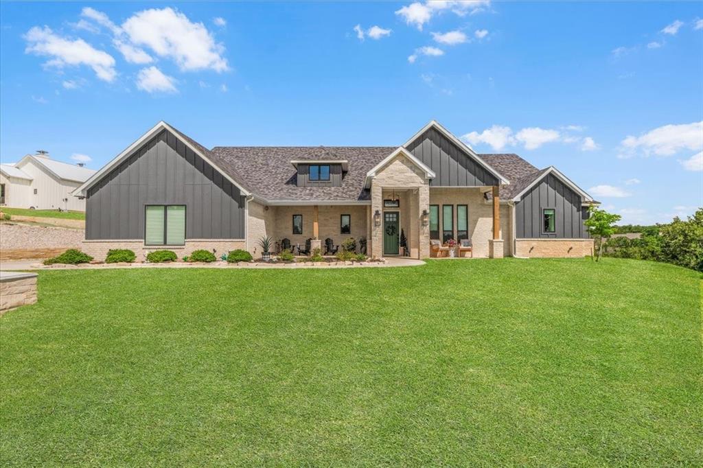 1059 Sweeney Way Weatherford, TX 76087 - Photo 1 of 37 Front of home with stone and vertical board-and-batten siding