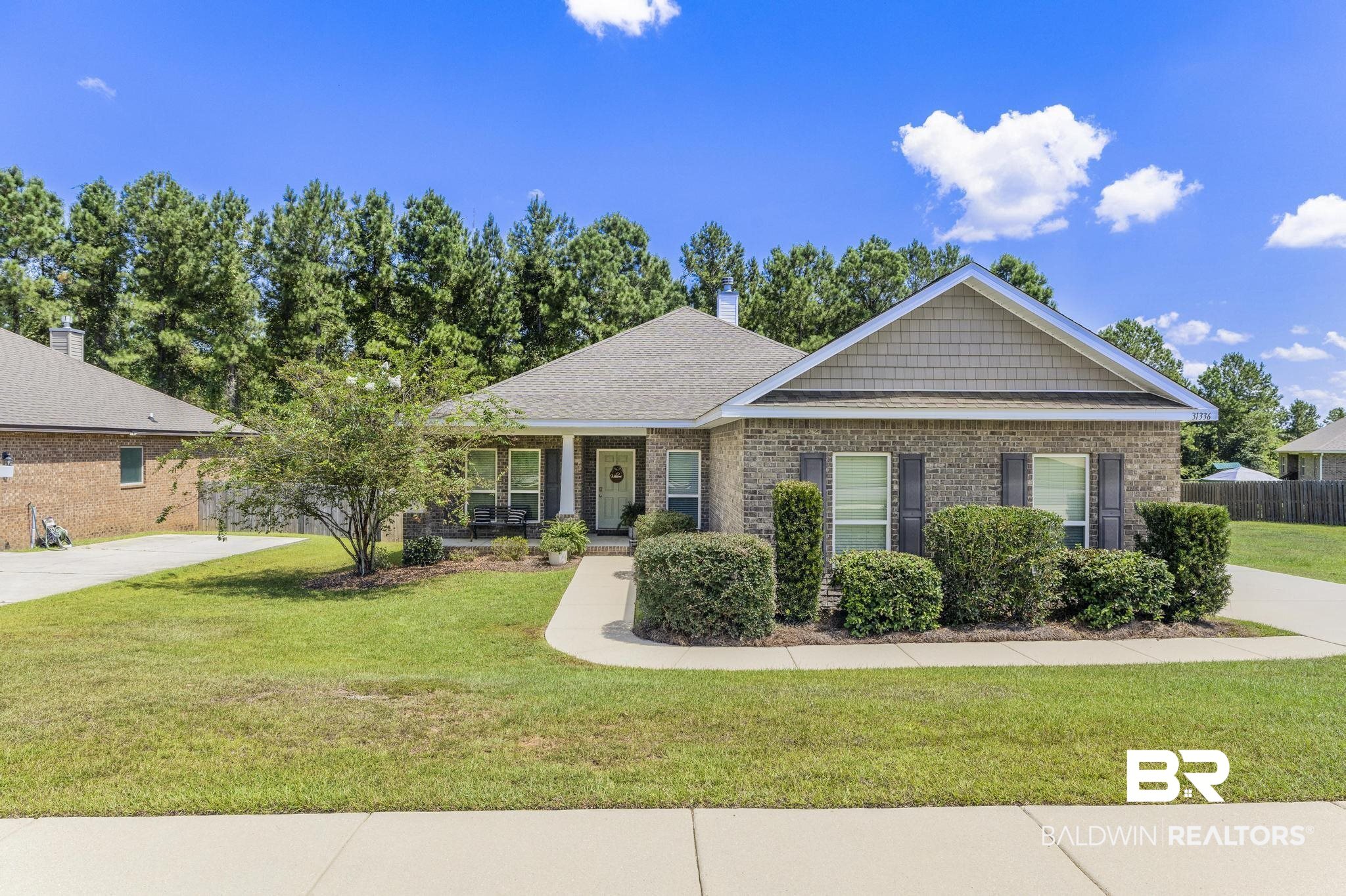 31336 Hoot Owl Road Daphne, AL 36527 - Photo 1 of 36 View of front of house with brick siding, a porch, a chimney, and a shingled roof