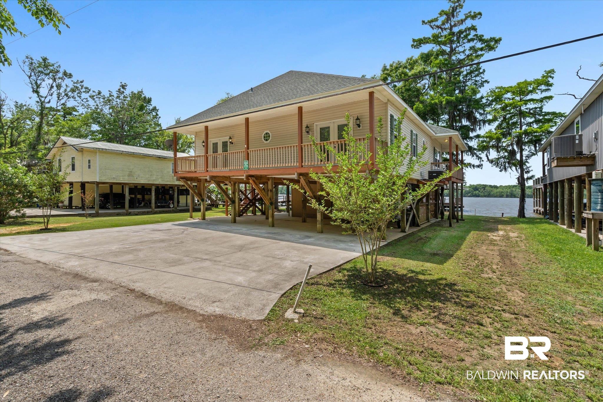 41923 Bayou Road Bay Minette, AL 36507 - Photo 32 of 35 Elevated residence featuring a covered front porch, double glass entry doors, and a decorative round window