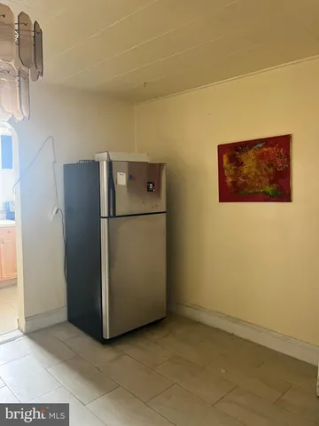 a view of a refrigerator in kitchen and furniture