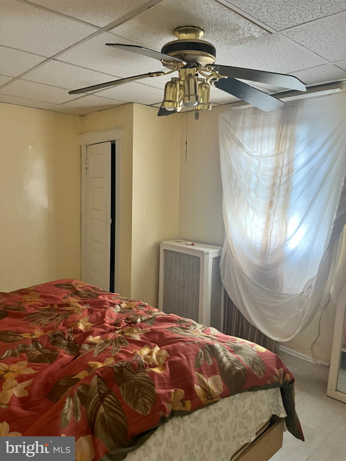 7123 Seaford Road Upper Darby, PA 19082 - Photo 6 of 6 a bedroom with a bed and a chandelier