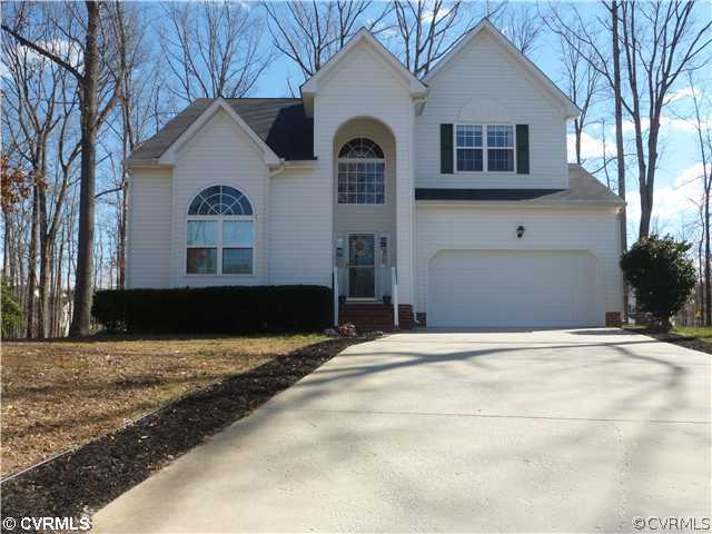 7801 Clover Ridge Place Chesterfield, VA 23832 - Photo 1 of 12 a front view of a house with a yard and garage