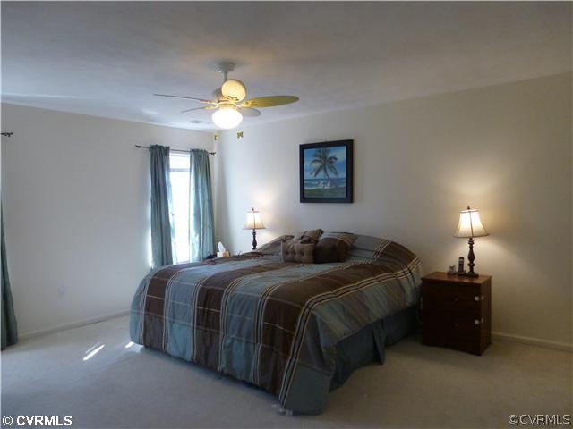 7801 Clover Ridge Place Chesterfield, VA 23832 - Photo 8 of 12 a bedroom with a bed and a chandelier