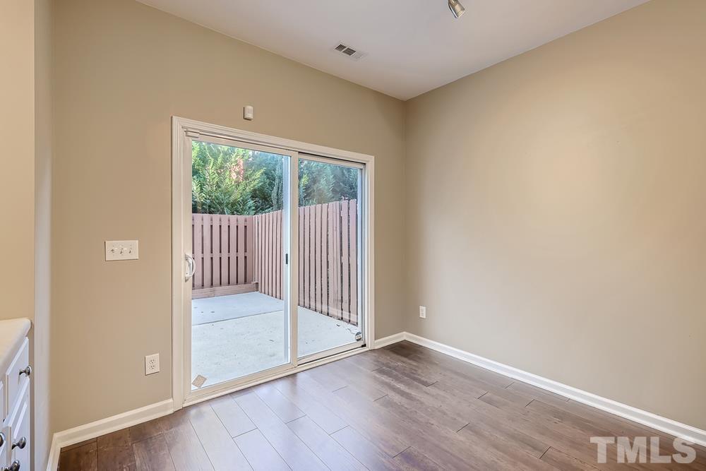 8155 Rhiannon Road Raleigh, NC 27613 - Photo 14 of 27 a view of a room with wooden floor and glass door