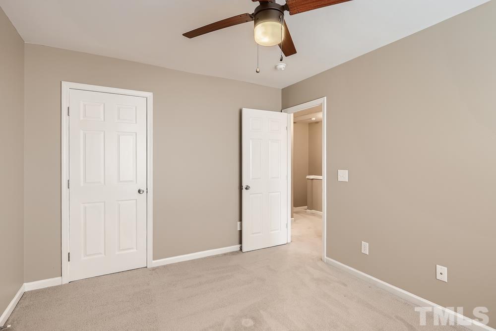 8155 Rhiannon Road Raleigh, NC 27613 - Photo 22 of 27 a view of an empty room and chandelier fan
