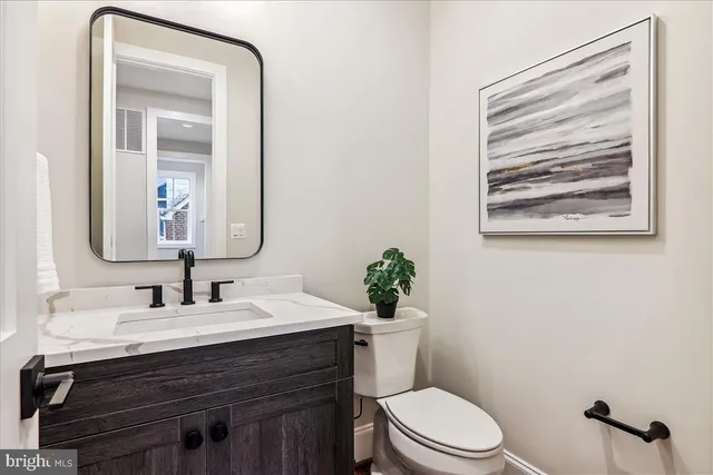 a living room with furniture fireplace and a large window