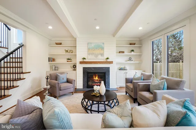 a kitchen with stainless steel appliances a stove a table a sink and a chairs