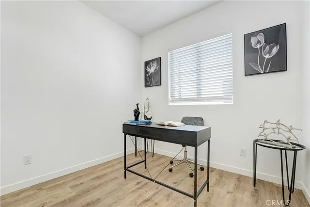 a view of a workspace with furniture and wooden floor