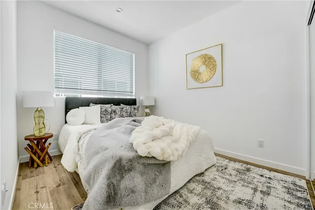 a bedroom with a bed and painting on the wall