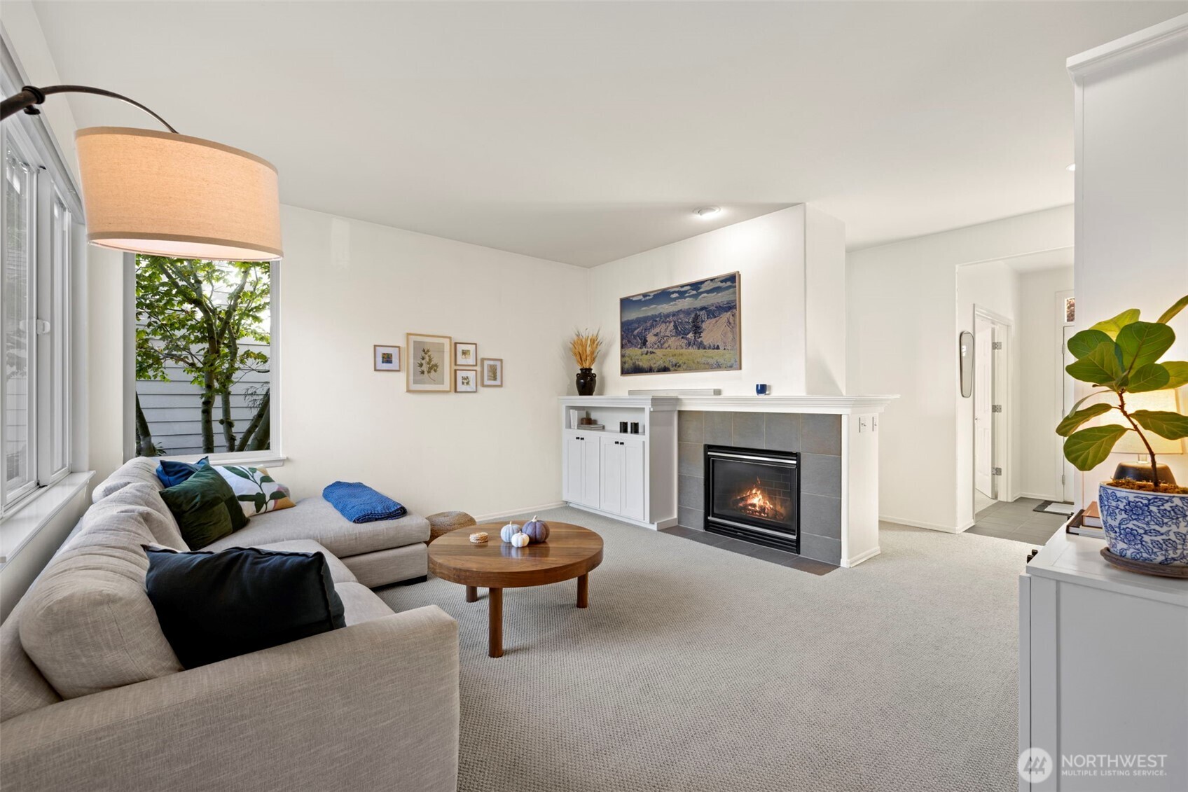 12058 Concord Way Mukilteo, WA 98275 - Photo 14 of 31 a living room with furniture a fireplace and a floor to ceiling window