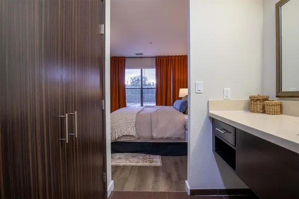 a en suite bathroom with a granite countertop sink and a mirror