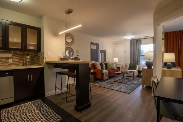 a living room with granite countertop furniture and wooden floor
