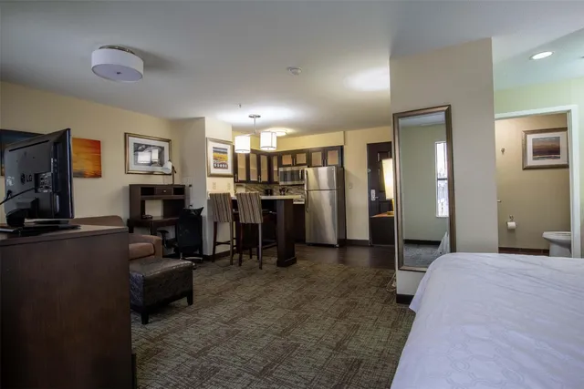 a bedroom with furniture and a flat screen tv