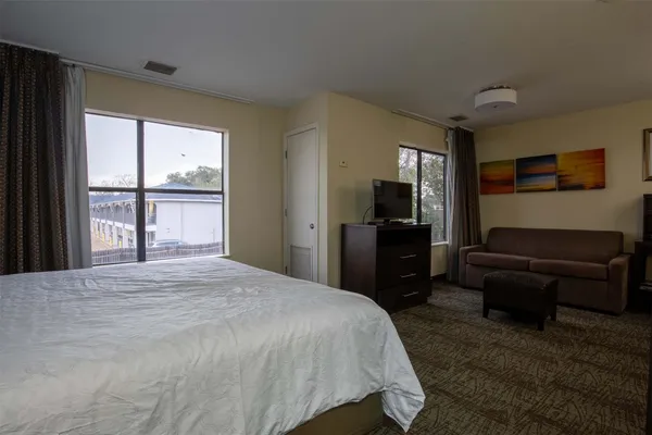 a bedroom with a bed and a large window