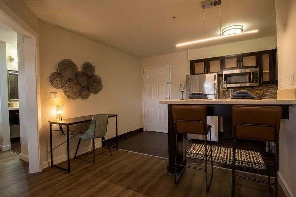 a dining room with furniture and window