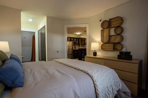 a bedroom with a bed and cabinets