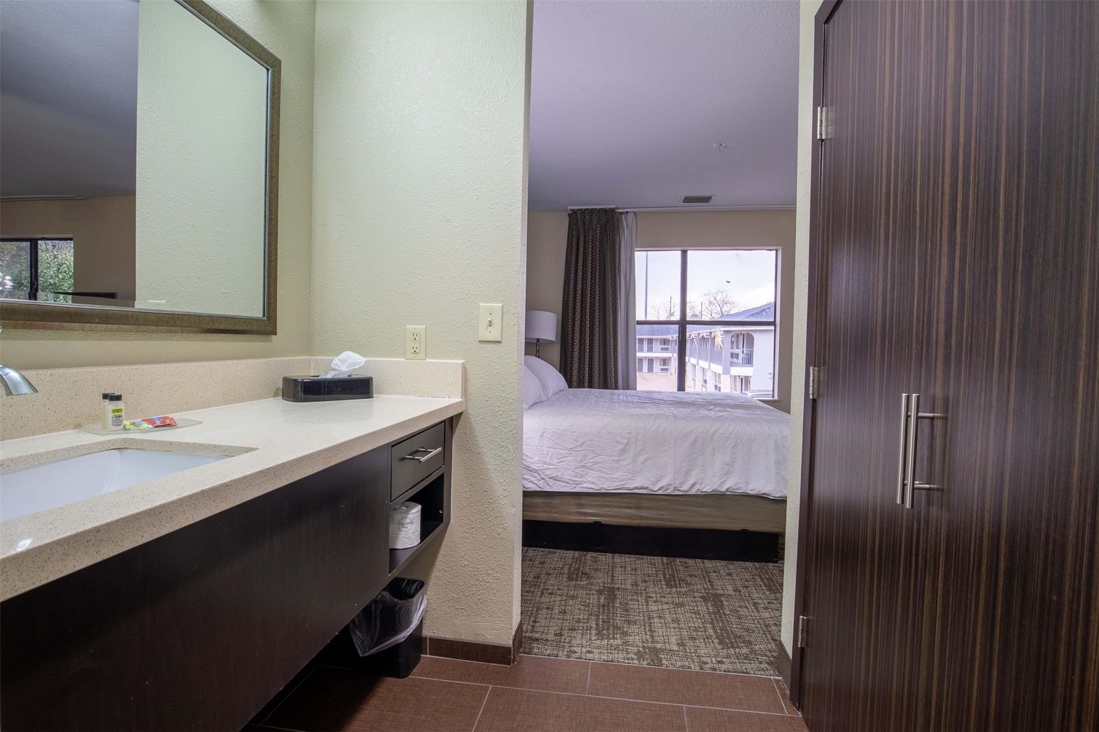 18828 Highway 249, Unit 201 Houston, TX 77070 - Photo 45 of 49 a en suite bathroom with a granite countertop sink and a mirror