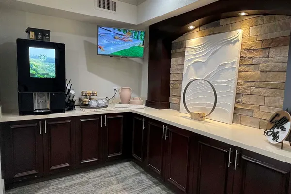 a kitchen with a sink and a wooden cabinets