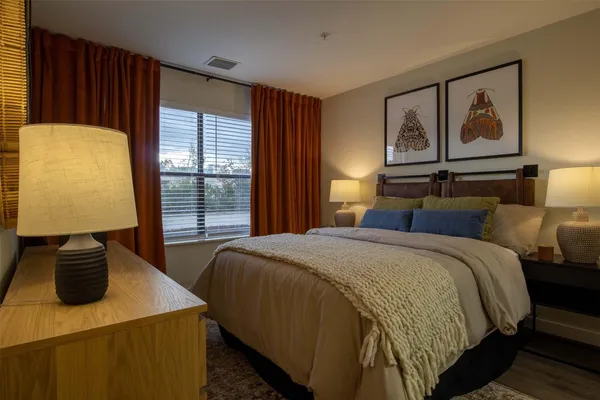 a bedroom with a bed and window