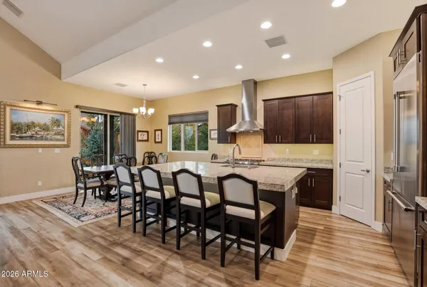 a large kitchen with a table and chairs