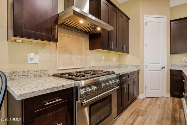 a kitchen with granite countertop a stove and a sink