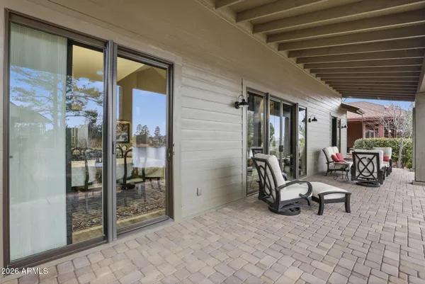a balcony with furniture and a glass door