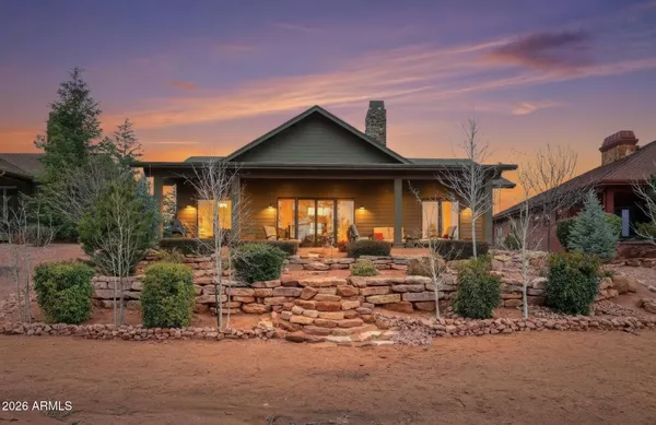a front view of a house with garden and plants
