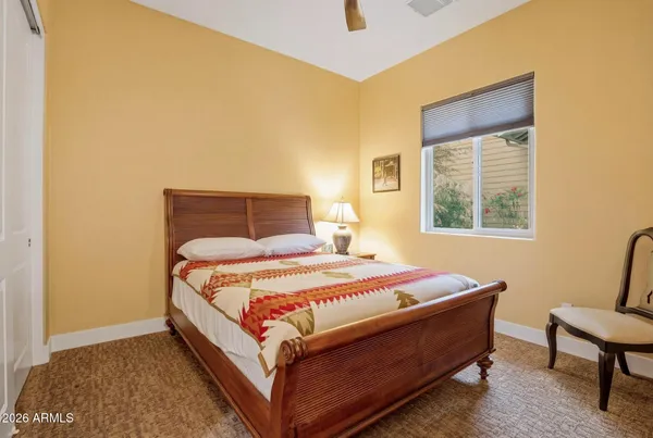 a bedroom with bed and window