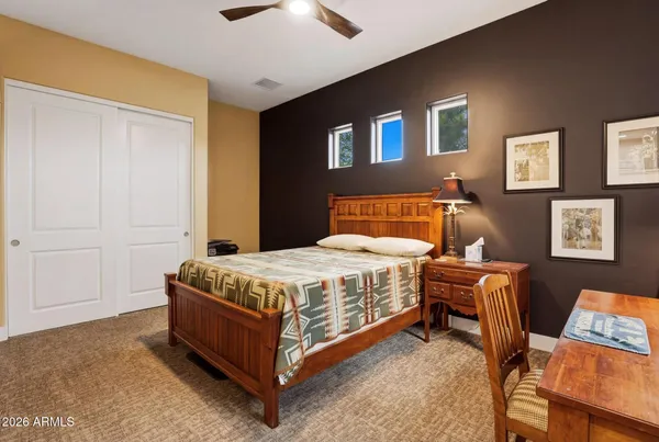 a bed sitting in a bedroom next to a window