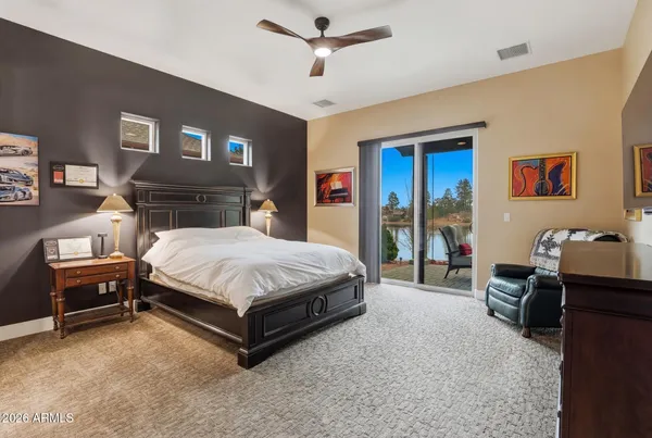 a bedroom with furniture and a ceiling fan