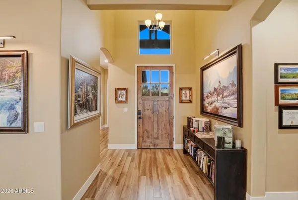 a view of a hallway with wooden floor and entryway