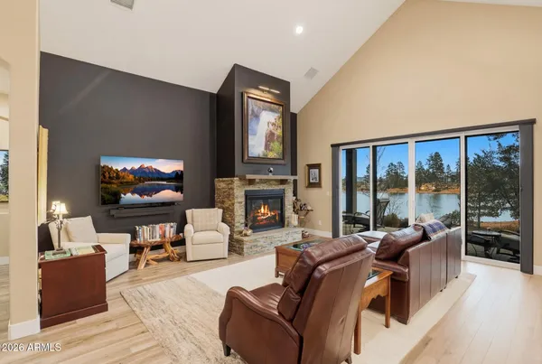 a living room with furniture a fireplace and a flat screen tv