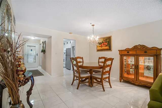a dining room with furniture and chandelier kitchen view