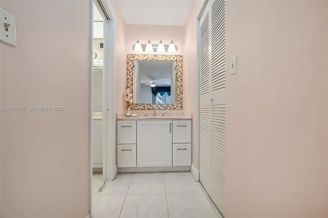 a bathroom with a granite countertop toilet a sink and a bathtub