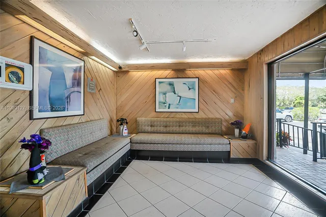 a view of a porch and garden in the back