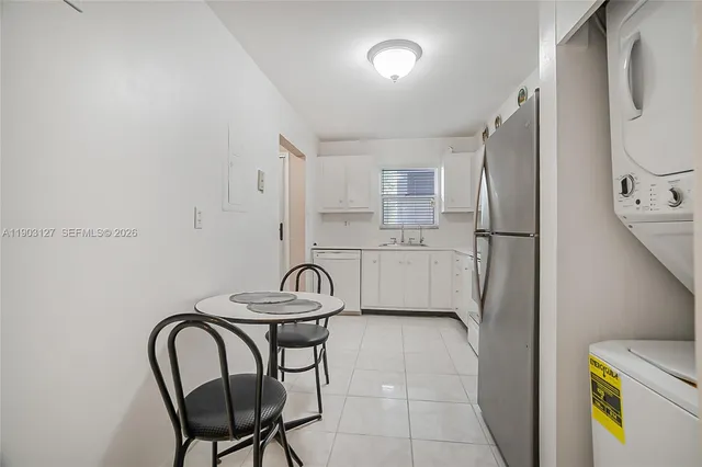 a kitchen with stainless steel appliances granite countertop a sink refrigerator and cabinets