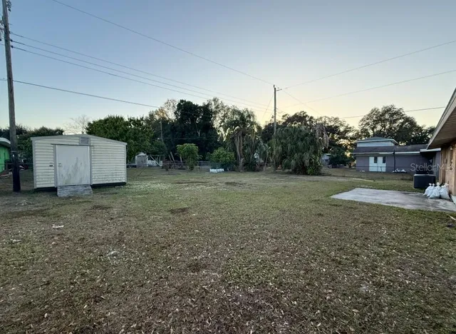 a view of a house with a backyard