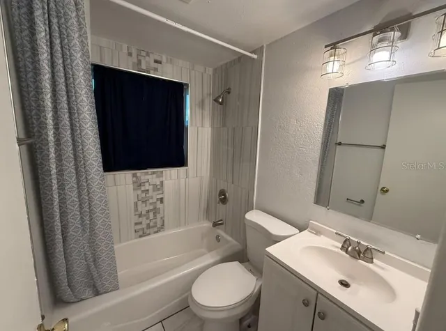 a bathroom with a sink toilet a mirror and shower