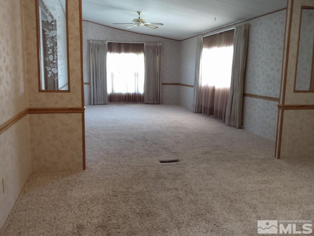 400 Scorpio Circle Reno, NV 89521 - Photo 4 of 11 an empty room with windows and refrigerator