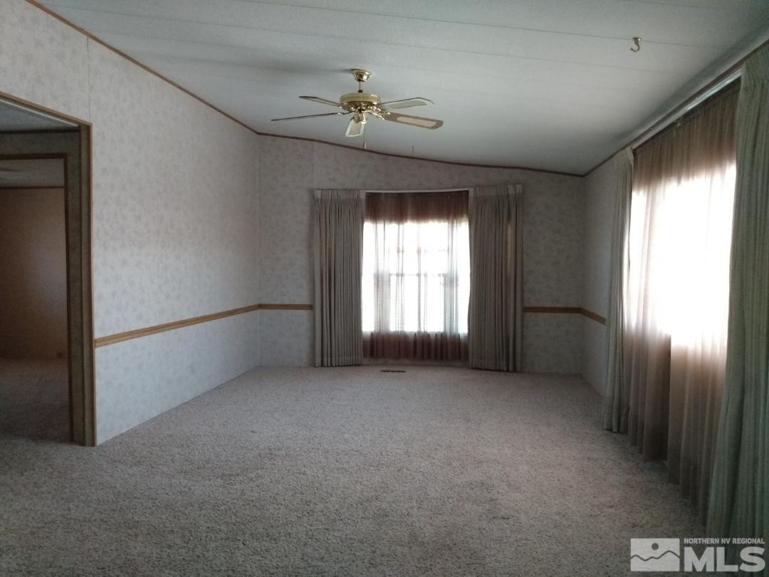 400 Scorpio Circle Reno, NV 89521 - Photo 5 of 11 an empty room with windows and chandelier fan