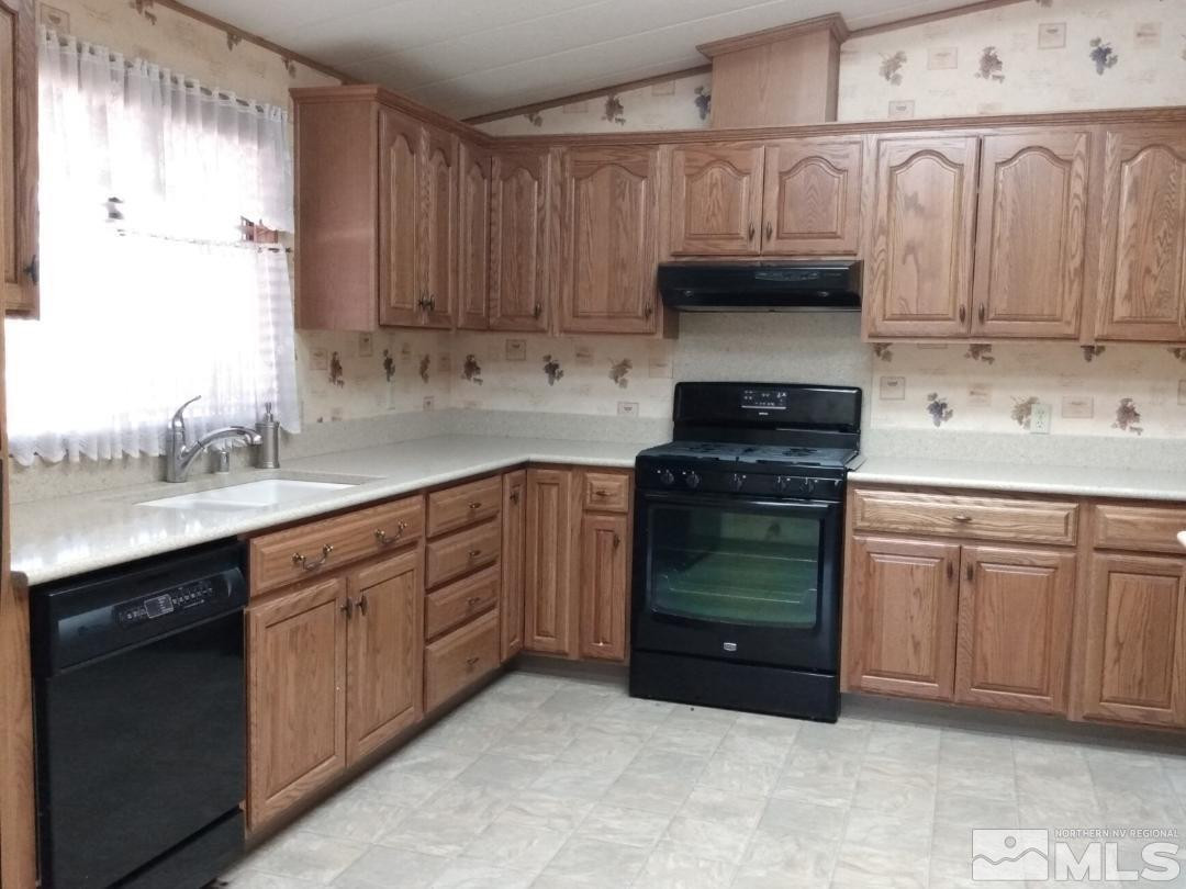 400 Scorpio Circle Reno, NV 89521 - Photo 7 of 11 a kitchen with granite countertop a sink and cabinets