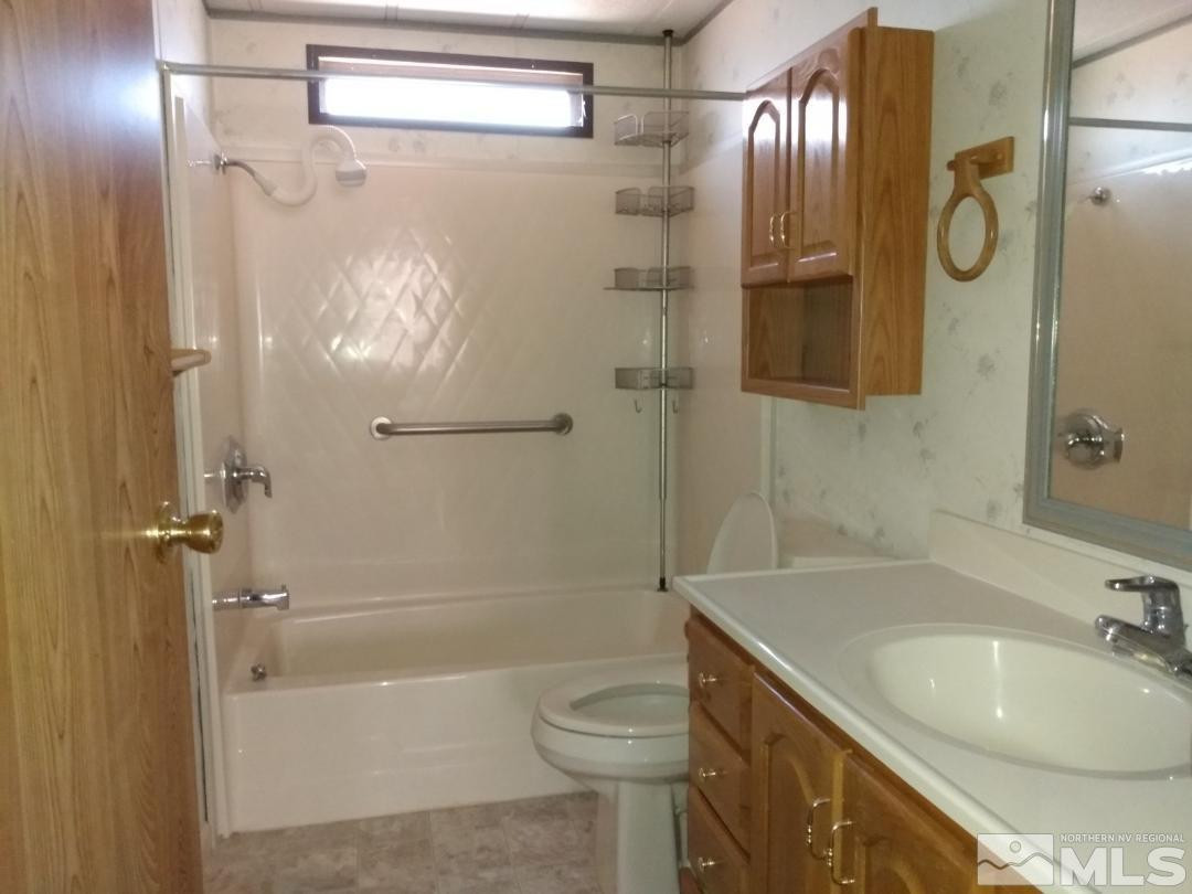 400 Scorpio Circle Reno, NV 89521 - Photo 10 of 11 a bathroom with a sink a toilet and shower