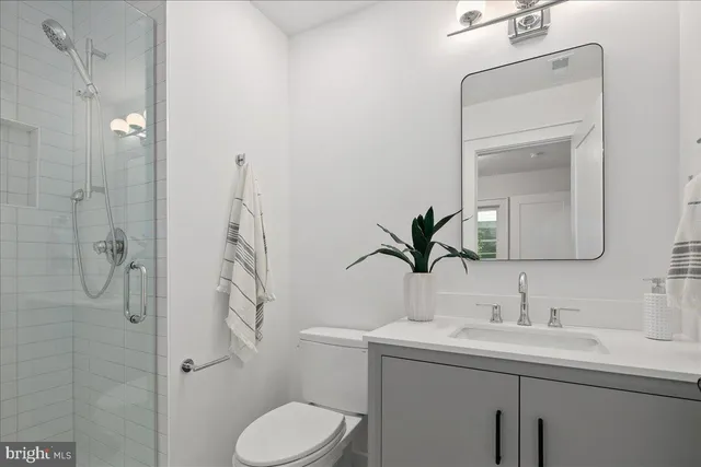a dining room with furniture a mirror and wooden floor