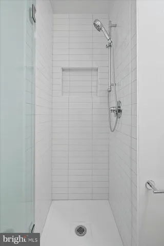 a kitchen with stainless steel appliances granite countertop a dining table chairs and view of living room